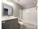 Bathroom with shower and tub, white vanity, and updated fixtures at 1295 Amber Ridge Nw Rd, Concord, NC 28027