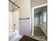 This bathroom features a white tub/shower combination and sleek black towel bar and fixtures at 1295 Amber Ridge Nw Rd, Concord, NC 28027