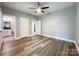 This bedroom is spacious and bright, with wood-look floors, neutral paint, and a ceiling fan at 1295 Amber Ridge Nw Rd, Concord, NC 28027