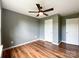 Bedroom featuring hardwood floors, neutral walls and a ceiling fan at 1295 Amber Ridge Nw Rd, Concord, NC 28027