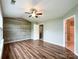 Bedroom featuring hardwood floors, shiplap accent wall, neutral walls, and a fan at 1295 Amber Ridge Nw Rd, Concord, NC 28027