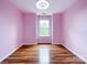 Bedroom featuring hardwood floors, a large window, and light-pink walls at 1295 Amber Ridge Nw Rd, Concord, NC 28027