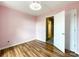 Bedroom featuring hardwood floors, a large window, and light-pink walls at 1295 Amber Ridge Nw Rd, Concord, NC 28027