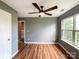 Bedroom featuring hardwood floors, neutral walls, a ceiling fan, and a window at 1295 Amber Ridge Nw Rd, Concord, NC 28027