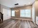 Bright dining area boasts wood floors, modern lighting, and two large windows at 1295 Amber Ridge Nw Rd, Concord, NC 28027