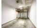 A clean, empty one-car garage with a concrete floor, ready for customization and offering direct access to the home at 1295 Amber Ridge Nw Rd, Concord, NC 28027
