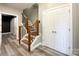 An inviting hallway with a wooden staircase, and wood-look flooring creating a welcoming entrance into the home at 1295 Amber Ridge Nw Rd, Concord, NC 28027