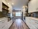 This galley kitchen features stainless appliances, white cabinets, subway tile backsplash, and modern lighting at 1295 Amber Ridge Nw Rd, Concord, NC 28027