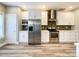 This kitchen features stainless appliances, white cabinets, granite counters, and a subway tile backsplash at 1295 Amber Ridge Nw Rd, Concord, NC 28027