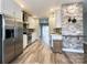 This kitchen features a suite of stainless appliances, modern lighting, and white cabinets at 1295 Amber Ridge Nw Rd, Concord, NC 28027
