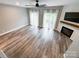 Spacious living room featuring lots of natural light and a fireplace with a wooden mantle at 1295 Amber Ridge Nw Rd, Concord, NC 28027