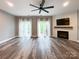 Living room featuring a fireplace, ceiling fan, wood-look floors, recessed lighting, and lots of natural light at 1295 Amber Ridge Nw Rd, Concord, NC 28027