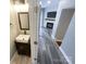 View of half bath with modern fixtures and a glimpse into the living room with a fireplace at 1295 Amber Ridge Nw Rd, Concord, NC 28027