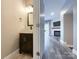 View of half bath with modern fixtures and a glimpse into the living room with a fireplace at 1295 Amber Ridge Nw Rd, Concord, NC 28027