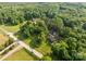 Aerial view of a wooded property with a road running through it and several houses nearby at 130 Casper Rd, Gold Hill, NC 28071