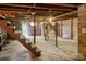Unfinished basement featuring concrete floors and exposed wooden staircase at 130 Casper Rd, Gold Hill, NC 28071