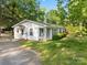 A charming home with white siding, green shutters, and a gravel driveway at 130 Casper Rd, Gold Hill, NC 28071