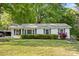 Charming single-story home with white siding, green shutters, and beautifully landscaped front yard at 130 Casper Rd, Gold Hill, NC 28071