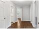 Hallway with hardwood floors and white trim leading to multiple rooms at 130 Casper Rd, Gold Hill, NC 28071