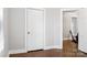 Hallway with hardwood floors, neutral walls, and multiple doorways providing access to rooms at 130 Casper Rd, Gold Hill, NC 28071