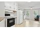 Bright kitchen with white appliances, tile floors, ceiling fan, and easy access to the outdoors at 130 Casper Rd, Gold Hill, NC 28071