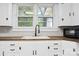Close-up of kitchen featuring white cabinets, wood countertops, sink and faucet at 130 Casper Rd, Gold Hill, NC 28071