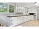 Well lit kitchen with lots of cabinets, light colored tile floor, and dark wood counters at 130 Casper Rd, Gold Hill, NC 28071