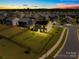 Aerial view of a fenced in yard, the neighborhood, solar panels, and a street at 133 W Neel Ranch Rd, Mooresville, NC 28115