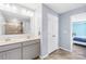Bathroom with double sinks, gray cabinets, a large mirror, and a shower with a glass door at 133 W Neel Ranch Rd, Mooresville, NC 28115
