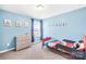 Blue bedroom with a twin bed, dresser and a view to the outdoors at 133 W Neel Ranch Rd, Mooresville, NC 28115