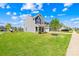 Inviting two-story gray home with green lawn, landscaping, and a two-car garage at 133 W Neel Ranch Rd, Mooresville, NC 28115