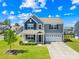 Charming two-story home with gray siding, well-manicured lawn, and attached two-car garage at 133 W Neel Ranch Rd, Mooresville, NC 28115