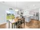 Modern kitchen with stainless steel appliances, light gray cabinets, and an island with a granite countertop at 133 W Neel Ranch Rd, Mooresville, NC 28115