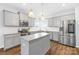 Stylish kitchen featuring gray cabinets, granite countertops, stainless steel appliances, and a center island at 133 W Neel Ranch Rd, Mooresville, NC 28115