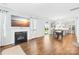 Open-concept living room boasts hardwood floors, fireplace, and a seamless flow into the dining and kitchen areas at 133 W Neel Ranch Rd, Mooresville, NC 28115