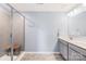 Modern main bathroom featuring dual sinks, a tile shower, and ample counter space at 133 W Neel Ranch Rd, Mooresville, NC 28115