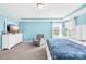 Light-filled main bedroom featuring a tray ceiling, ample natural light, and an inviting armchair at 133 W Neel Ranch Rd, Mooresville, NC 28115