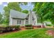 Charming backyard view featuring a two-story home, well-maintained lawn, and a wood deck at 134 Lawrence Tee Ln, Mooresville, NC 28117
