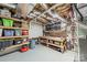 Unfinished basement with open ceiling, storage shelving and workbench at 134 Lawrence Tee Ln, Mooresville, NC 28117