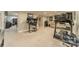 Spacious finished basement with exercise equipment, office area, and cozy seating for relaxation at 134 Lawrence Tee Ln, Mooresville, NC 28117
