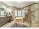 Luxurious bathroom featuring a soaking tub, glass-enclosed shower, and double vanity at 134 Lawrence Tee Ln, Mooresville, NC 28117