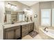 Bright bathroom with granite counters, double sinks, soaking tub, and a glass enclosed shower at 134 Lawrence Tee Ln, Mooresville, NC 28117