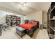 Stylish bedroom featuring a ceiling fan, red and black bedding, dark furniture, and shelving at 134 Lawrence Tee Ln, Mooresville, NC 28117