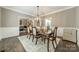Elegant dining room with a stylish chandelier and a view into the living room at 134 Lawrence Tee Ln, Mooresville, NC 28117