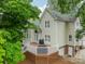 Back exterior view of home with deck, barbecue and walk out basement door at 134 Lawrence Tee Ln, Mooresville, NC 28117