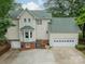 Rear exterior showcasing garage, bay window and well-maintained concrete driveway at 134 Lawrence Tee Ln, Mooresville, NC 28117