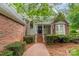 Inviting home entrance with brick walkway and manicured shrubbery at 134 Lawrence Tee Ln, Mooresville, NC 28117