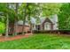 Charming brick home with a well-manicured lawn and mature trees in a peaceful setting at 134 Lawrence Tee Ln, Mooresville, NC 28117