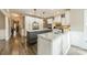 Spacious kitchen features two large islands, white cabinets, granite countertops, and stainless steel appliances at 134 Lawrence Tee Ln, Mooresville, NC 28117