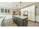 Spacious kitchen with a large center island, ample cabinetry, and stainless steel refrigerator at 134 Lawrence Tee Ln, Mooresville, NC 28117